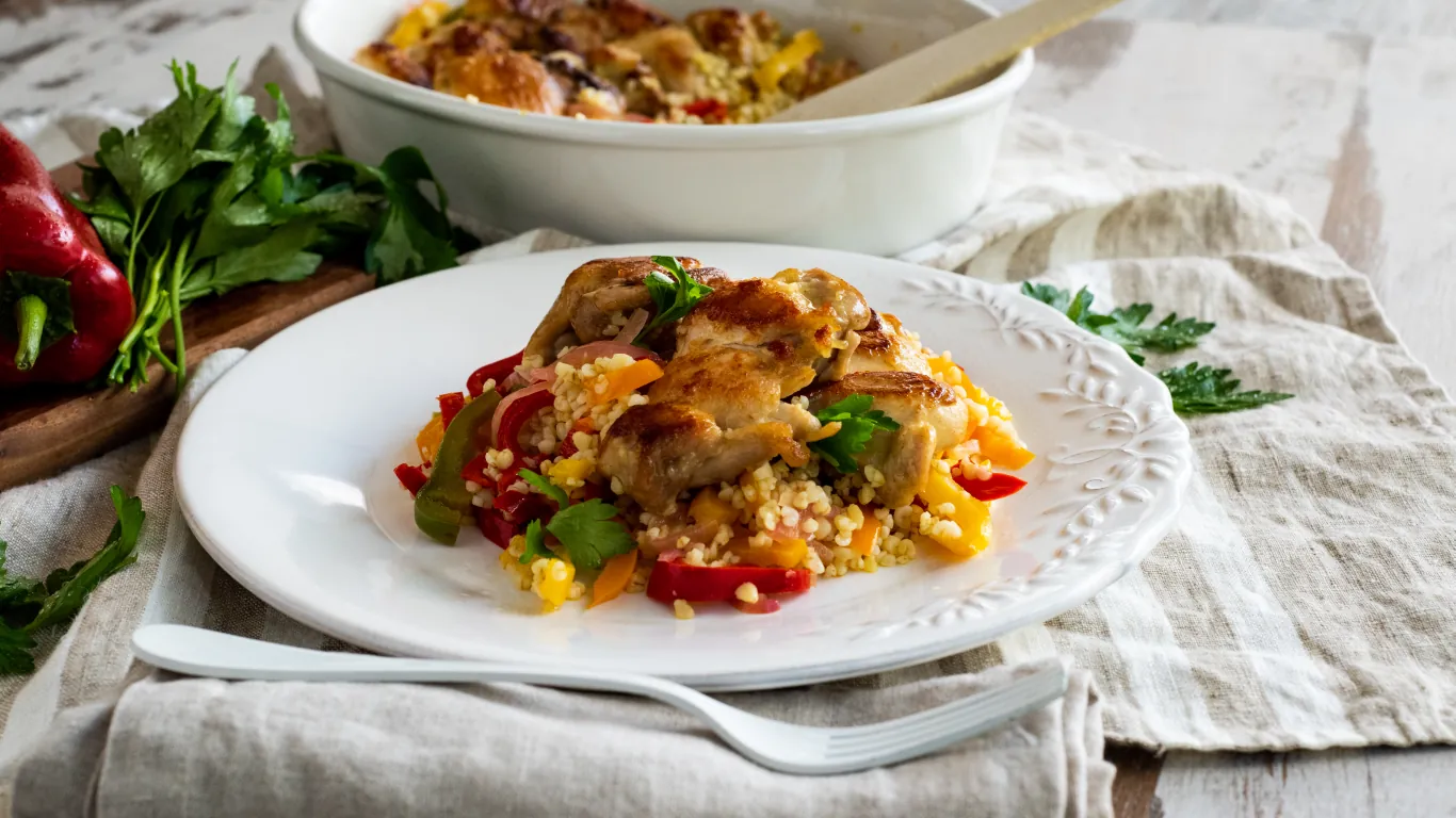 Oven-baked Chicken Leg Fillets with Colorful Peppers and Bulgur Aggelakis